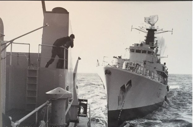 Bow-on view of a Royal Navy frigate bearing down on an Icelandic Coast Guard vessel